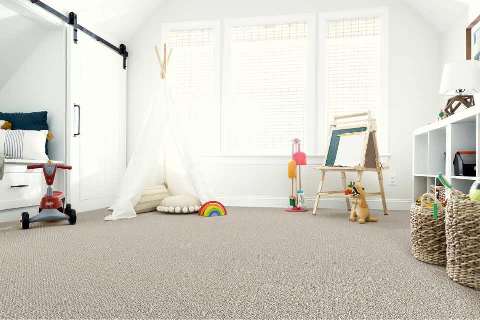 grey looped carpet in modern kids room with barn door details